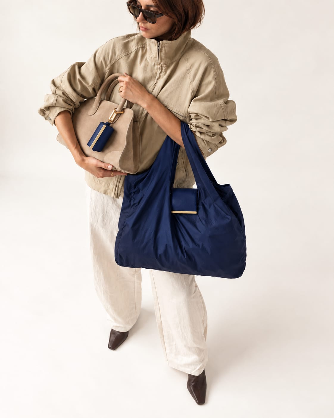 Model met de uitgevouwen Dark Blue tote en het opgerolde hoesje